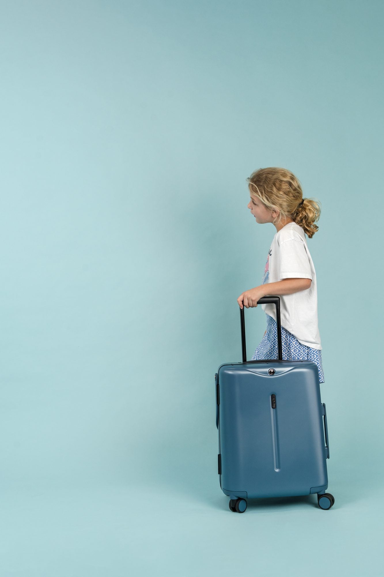 A child pulling a Slate Blue Carry On