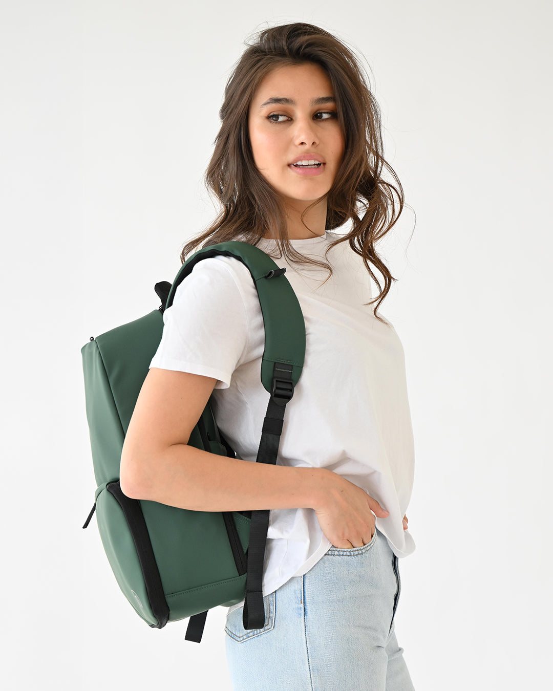 The Forest Green Expandable Backpack worn over one shoulder