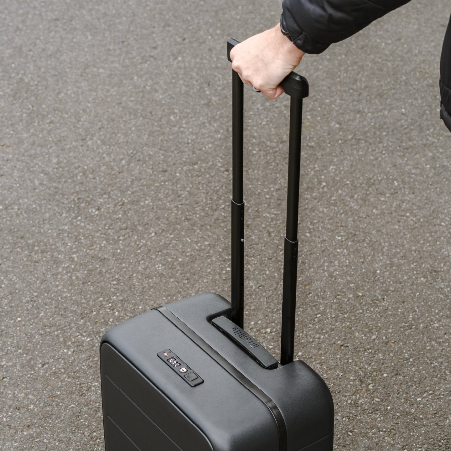 Pulling a black Carry On Pro along the street